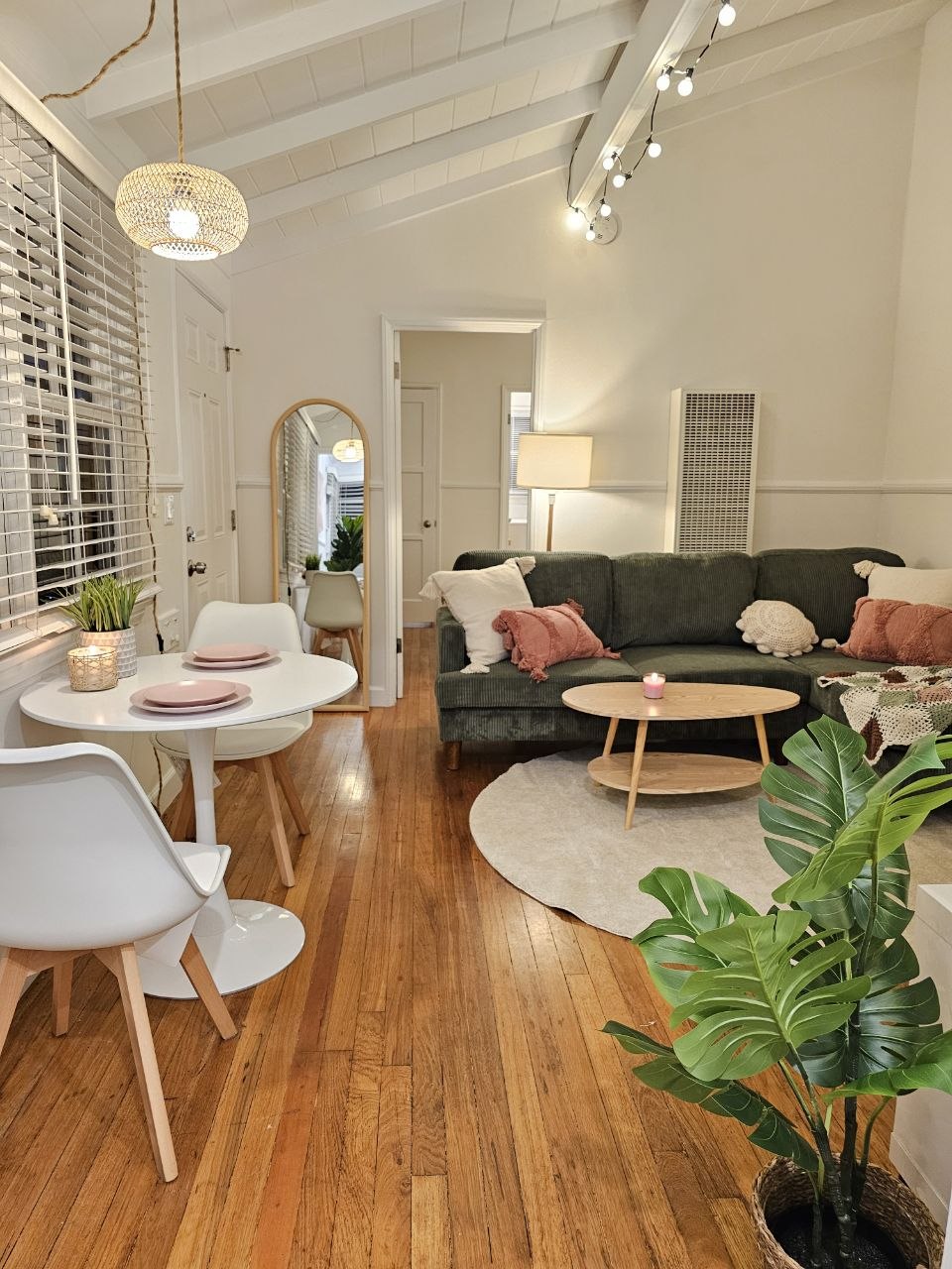 Bright furnished bedroom with warm wood floors